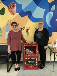 Carol Stirton-Broad and Suzanne Daub donate the "little library" to FPCN